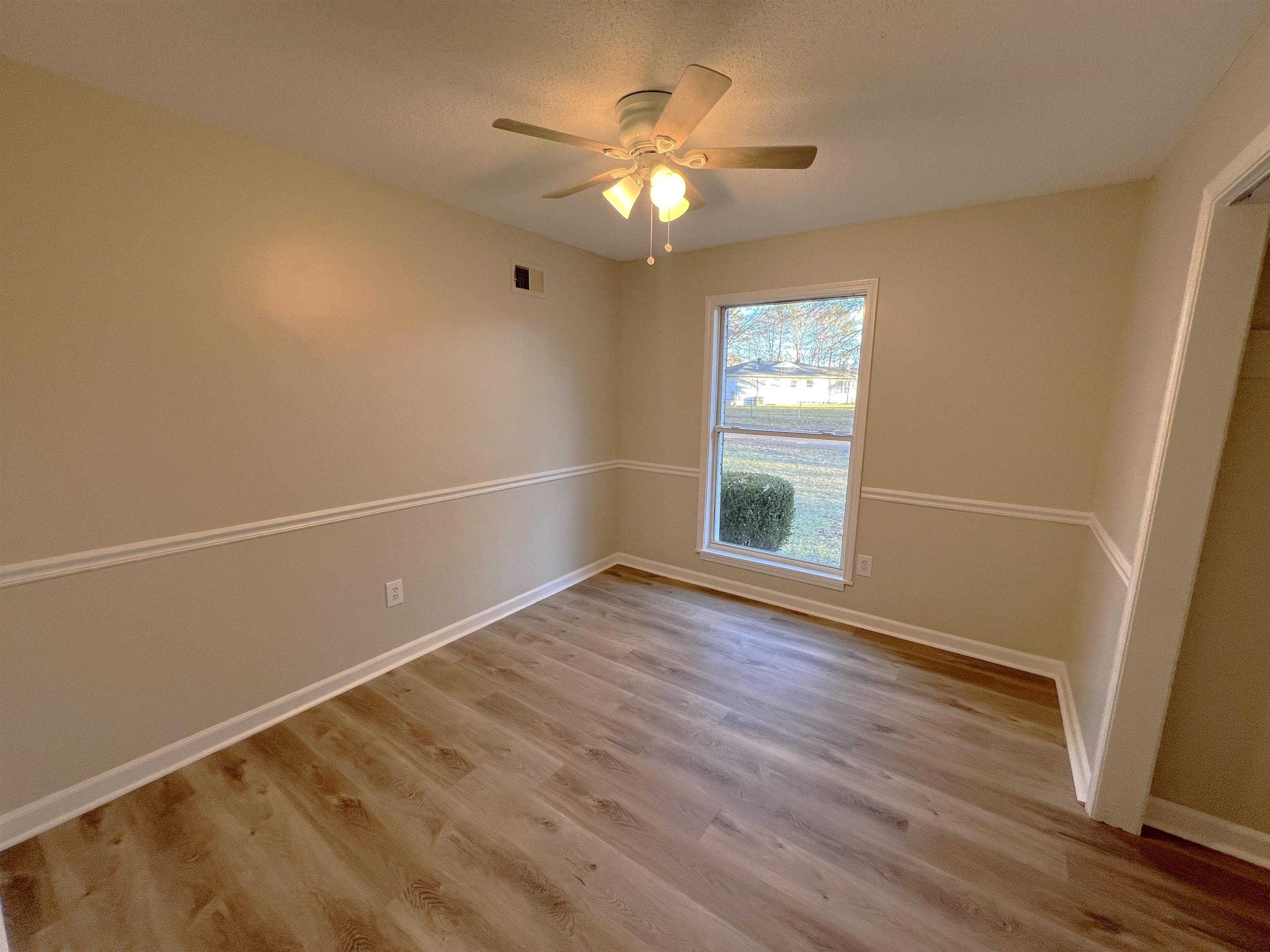 993 Poplar Leaf Road Collierville, TN 38017 - Photo 11 of 20 an empty room with wooden floor and windows