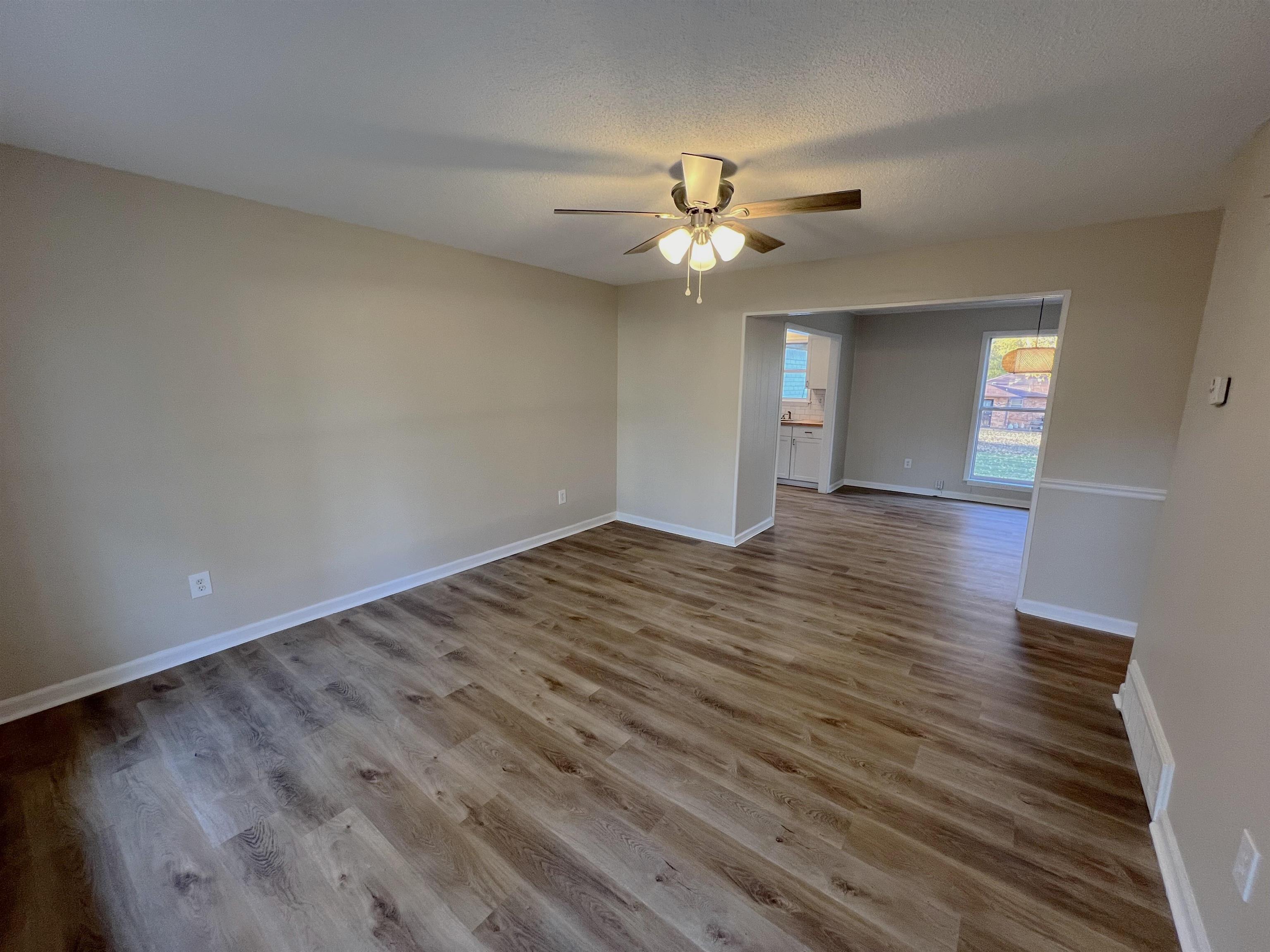 993 Poplar Leaf Road Collierville, TN 38017 - Photo 2 of 20 wooden floor in an empty room with a window
