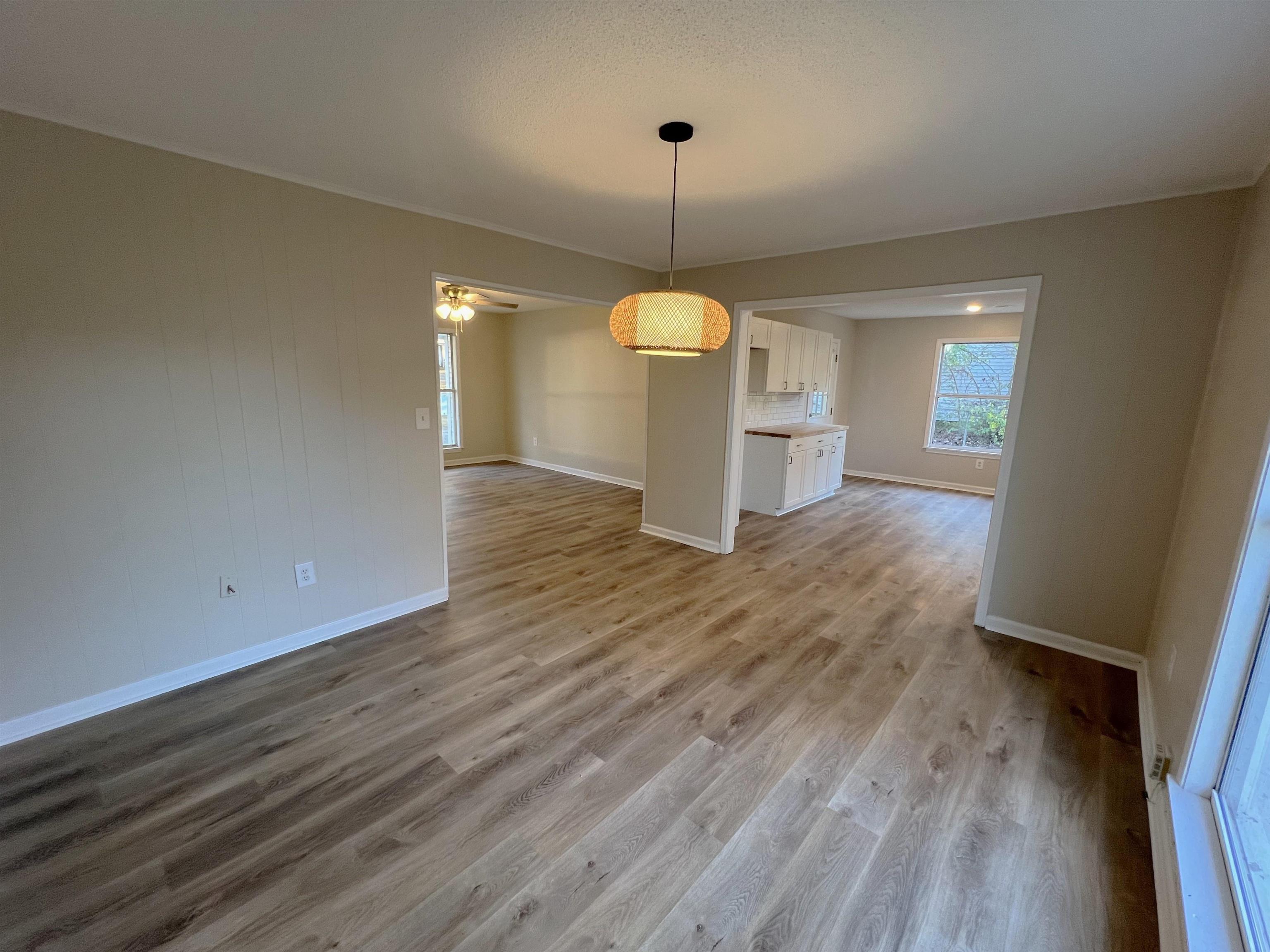 993 Poplar Leaf Road Collierville, TN 38017 - Photo 4 of 20 a view of a room with wooden floor and a ceiling fan
