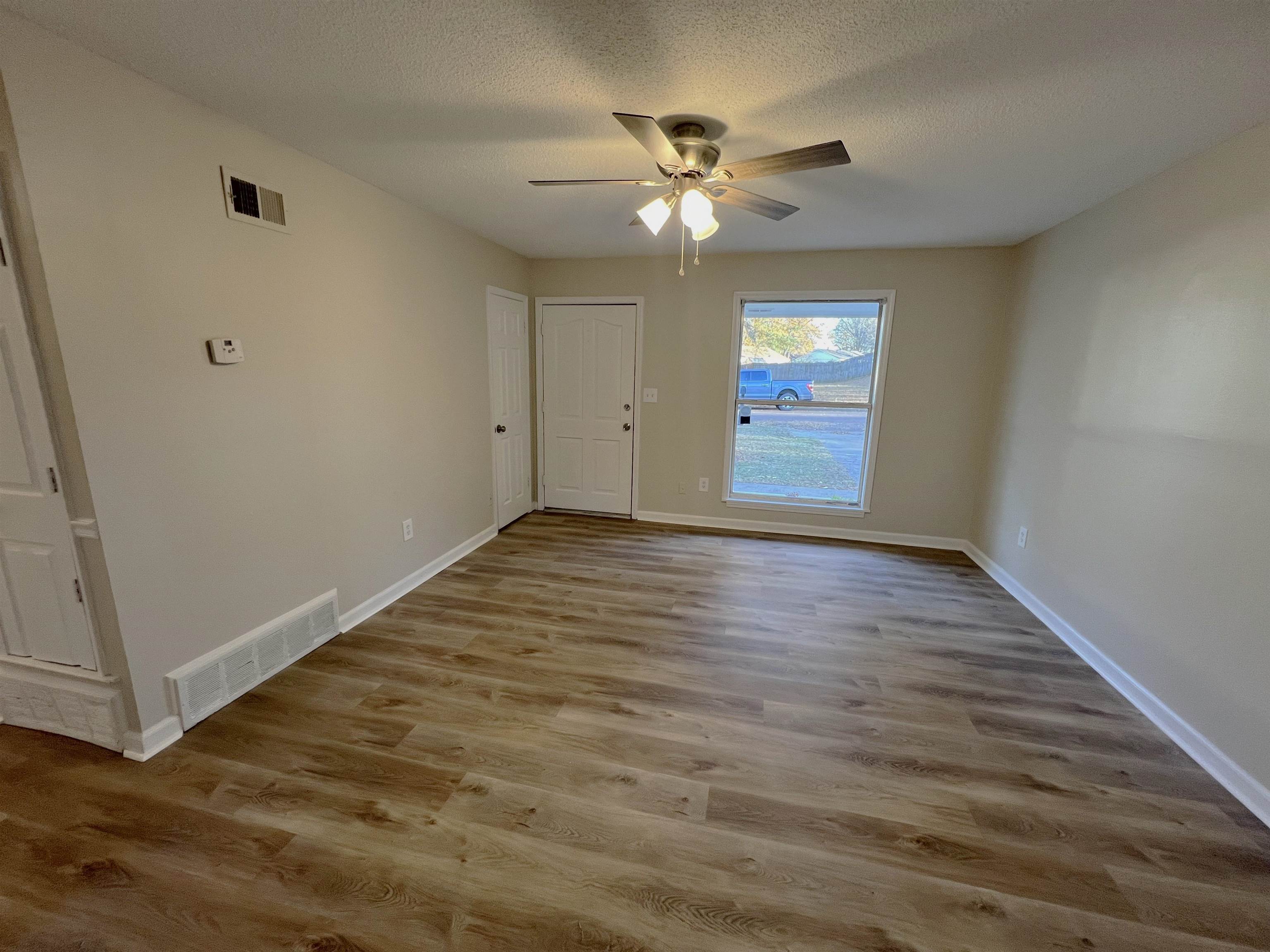 993 Poplar Leaf Road Collierville, TN 38017 - Photo 8 of 20 a view of an empty room with window and wooden floor