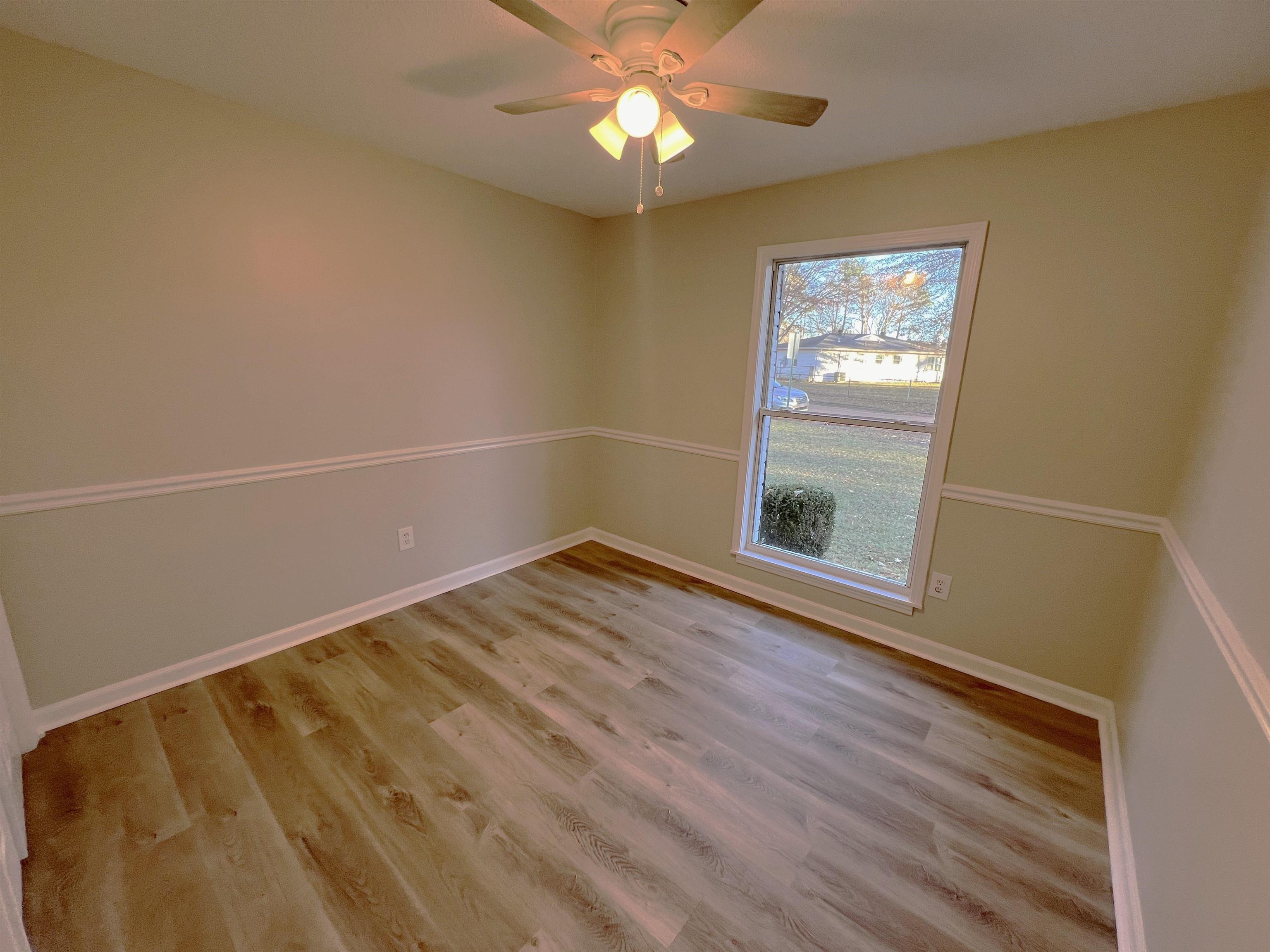 993 Poplar Leaf Road Collierville, TN 38017 - Photo 10 of 20 wooden floor in an empty room with a window