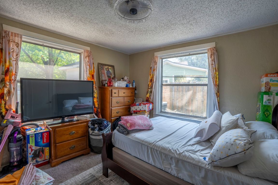 4801 Lott Avenue Austin, TX 78721 - Photo 8 of 20 a bedroom with furniture and a flat screen tv