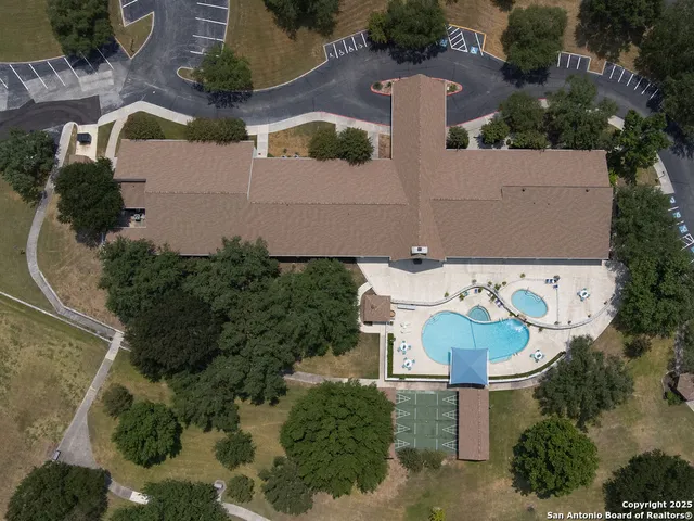 an aerial view of a house with a yard