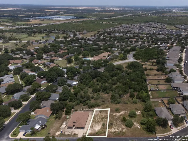 an aerial view of a house with a yard