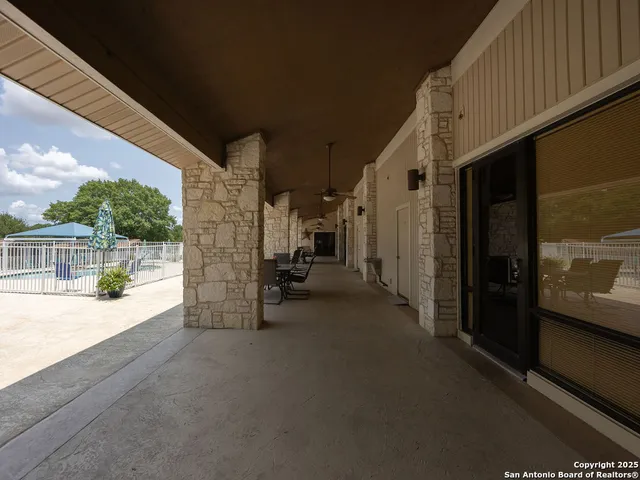 a view of a white house with wooden fence