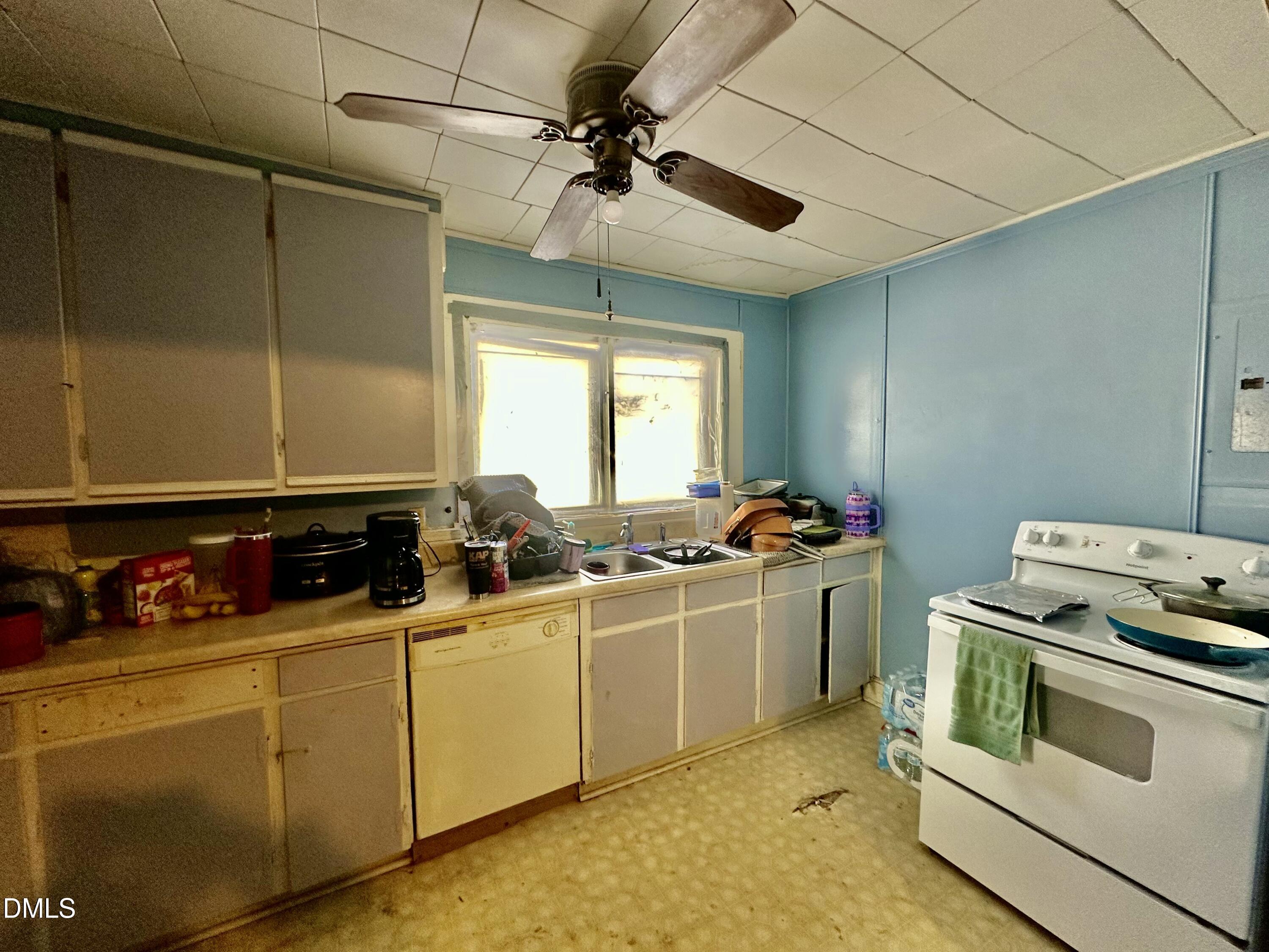 142 Yarborough Street Roxboro, NC 27573 - Photo 6 of 12 a kitchen with a sink a stove and cabinets