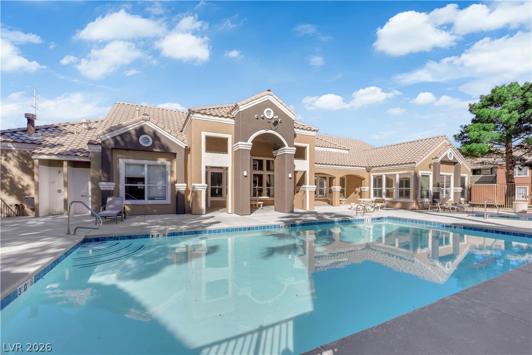 A sparkling pool invites relaxation beside this attractive community clubhouse.