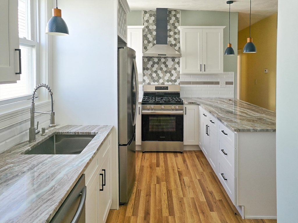 23 Ralph Piteri Terrace, Unit 3 Watertown, MA 02472 - Photo 2 of 7 a kitchen with granite countertop a sink and cabinets