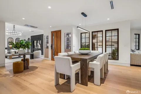 a living room with furniture and a dining table with kitchen view