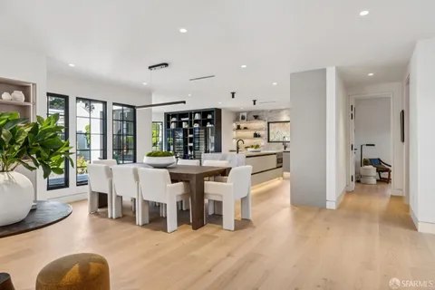 a large kitchen with kitchen island a large counter top space a sink stainless steel appliances and cabinets