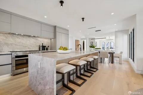 a living room with furniture and a kitchen