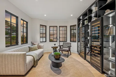 a bedroom with a bed and glass windows