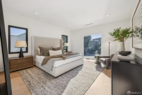 a living room with couches and dining table with wooden floor