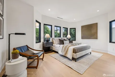 a living room with furniture a chandelier and a mirror