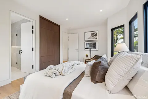 a living room with fireplace furniture and a large window