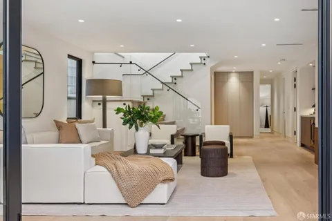 a living room with furniture a dining table and a lamp with wooden floor