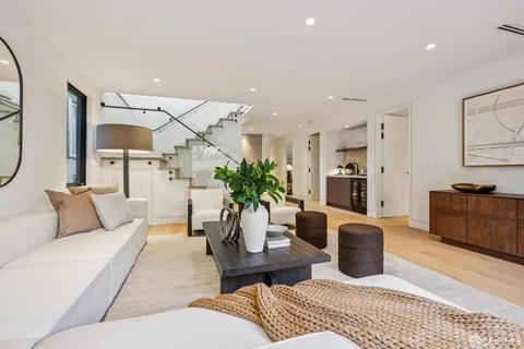 a view of a patio with table and chairs with wooden floor and fence