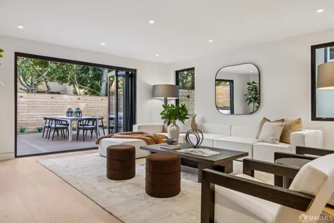 a view of a patio with table and chairs with wooden floor and fence