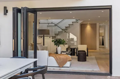 an aerial view of a house with a yard and large trees