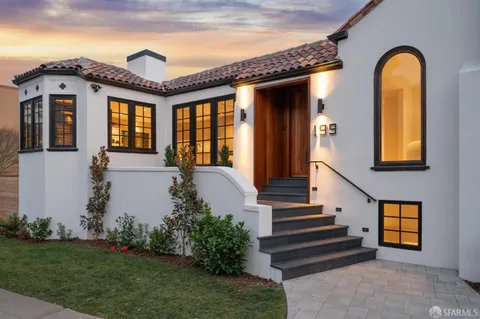 a view of a porch with furniture and garden
