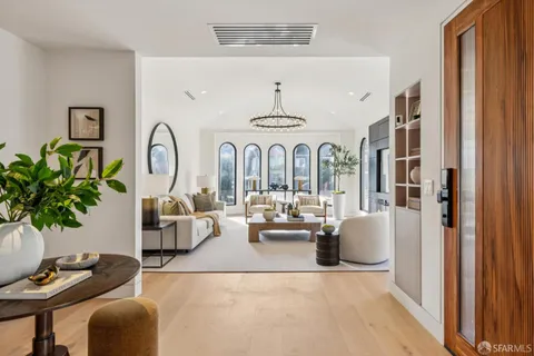 a living room with fireplace furniture and a large window