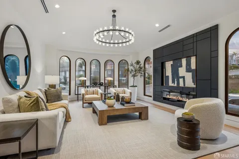 a living room with furniture a couch and a chandelier