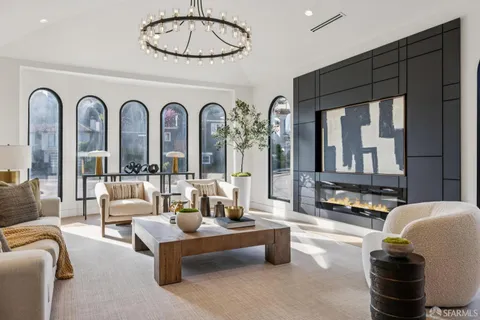 a living room with furniture and a potted plant