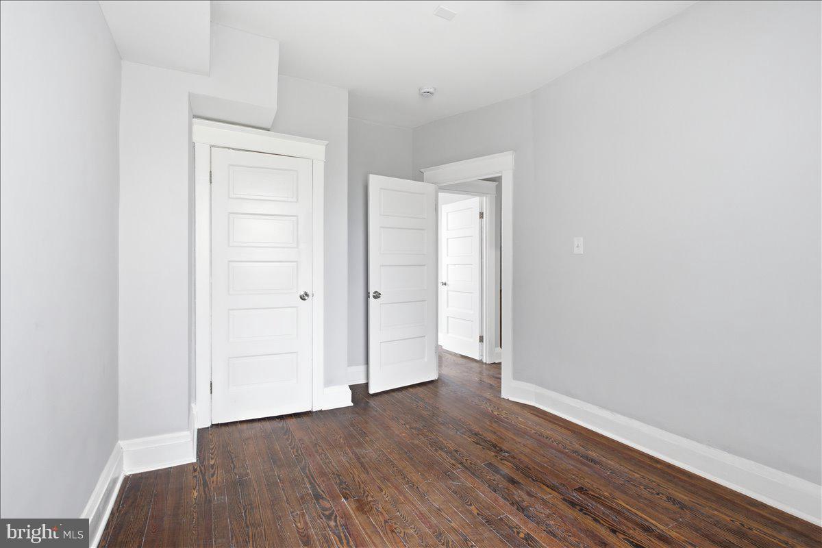 1231 North Potomac Street Baltimore, MD 21213 - Photo 15 of 25 a view of an empty room with wooden floor