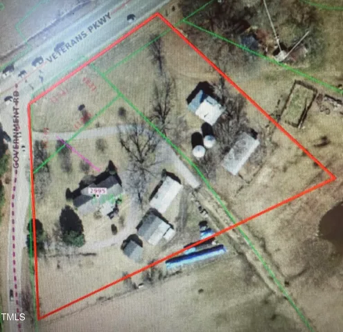 an aerial view of a house with a yard