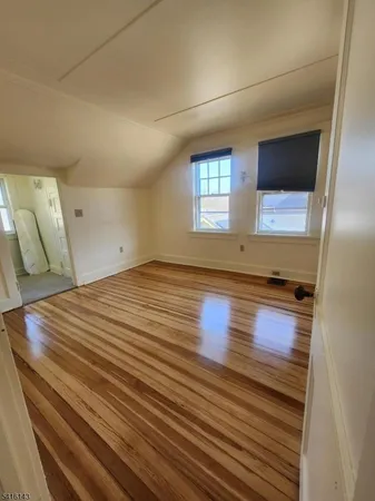 a view of room with window and wooden floor