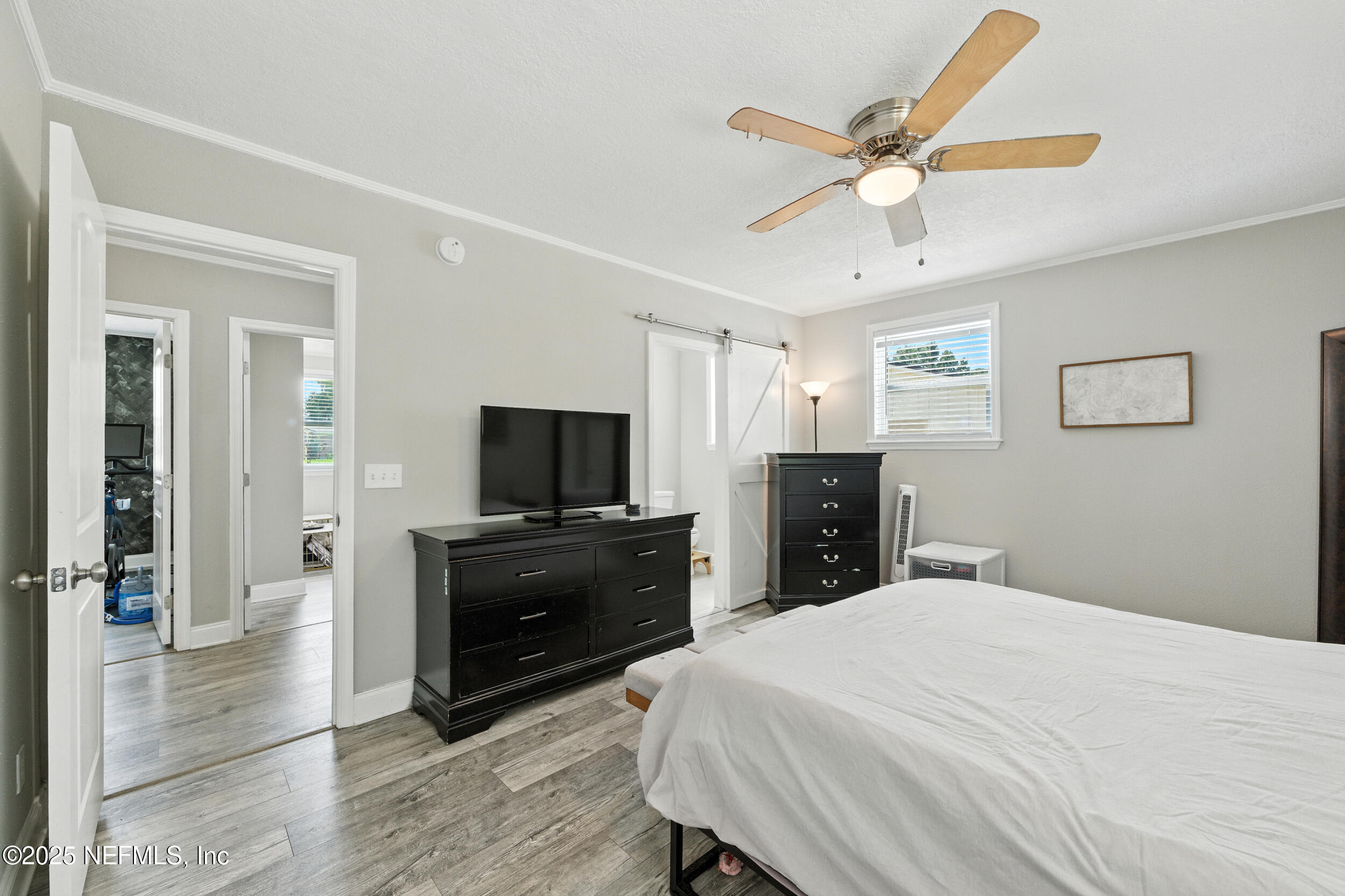 706 Estates Cove Road Jacksonville, FL 32221 - Photo 14 of 26 a bedroom with a bed and a flat screen tv