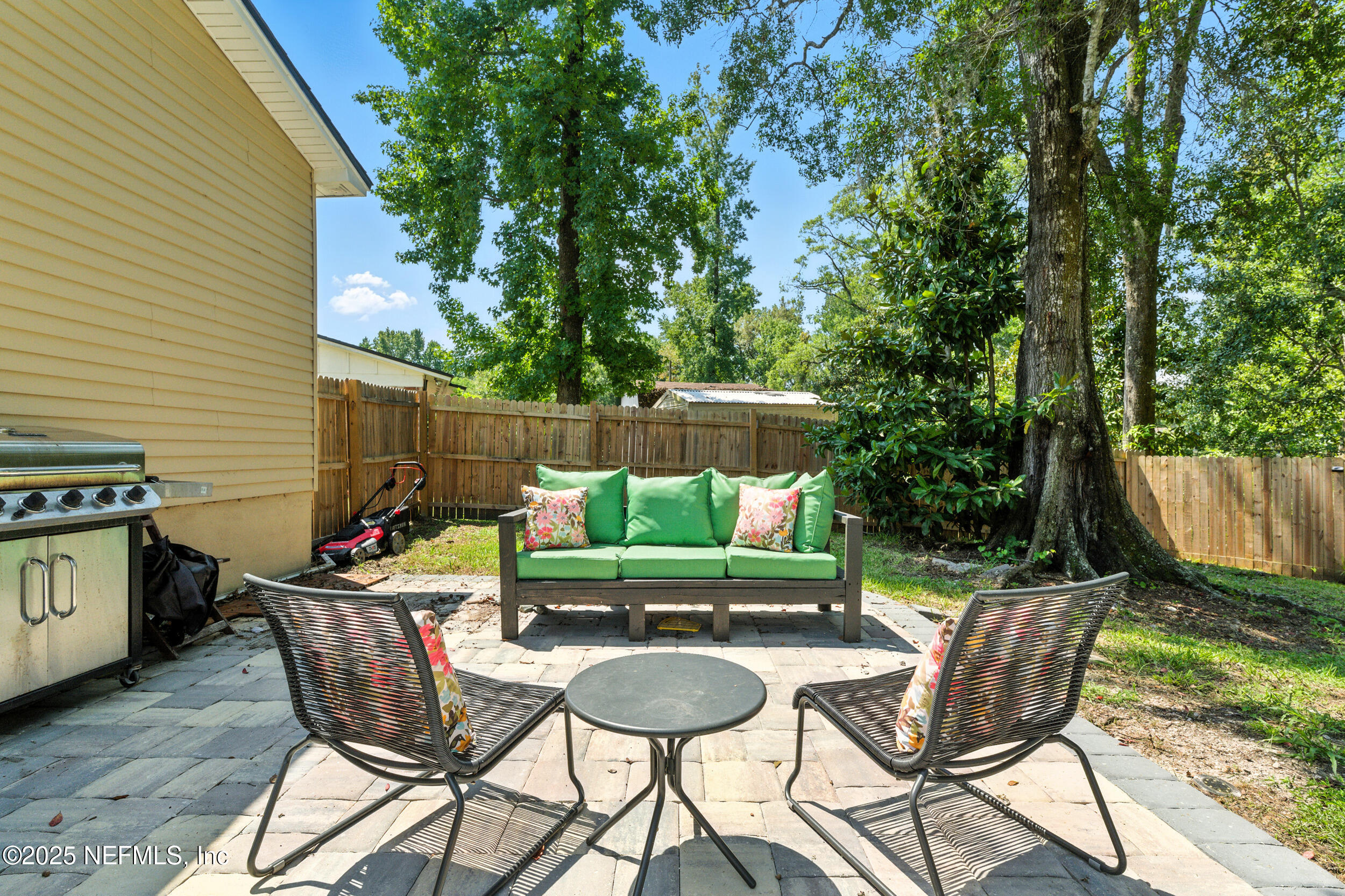 706 Estates Cove Road Jacksonville, FL 32221 - Photo 23 of 26 a backyard of a house with yard and outdoor seating