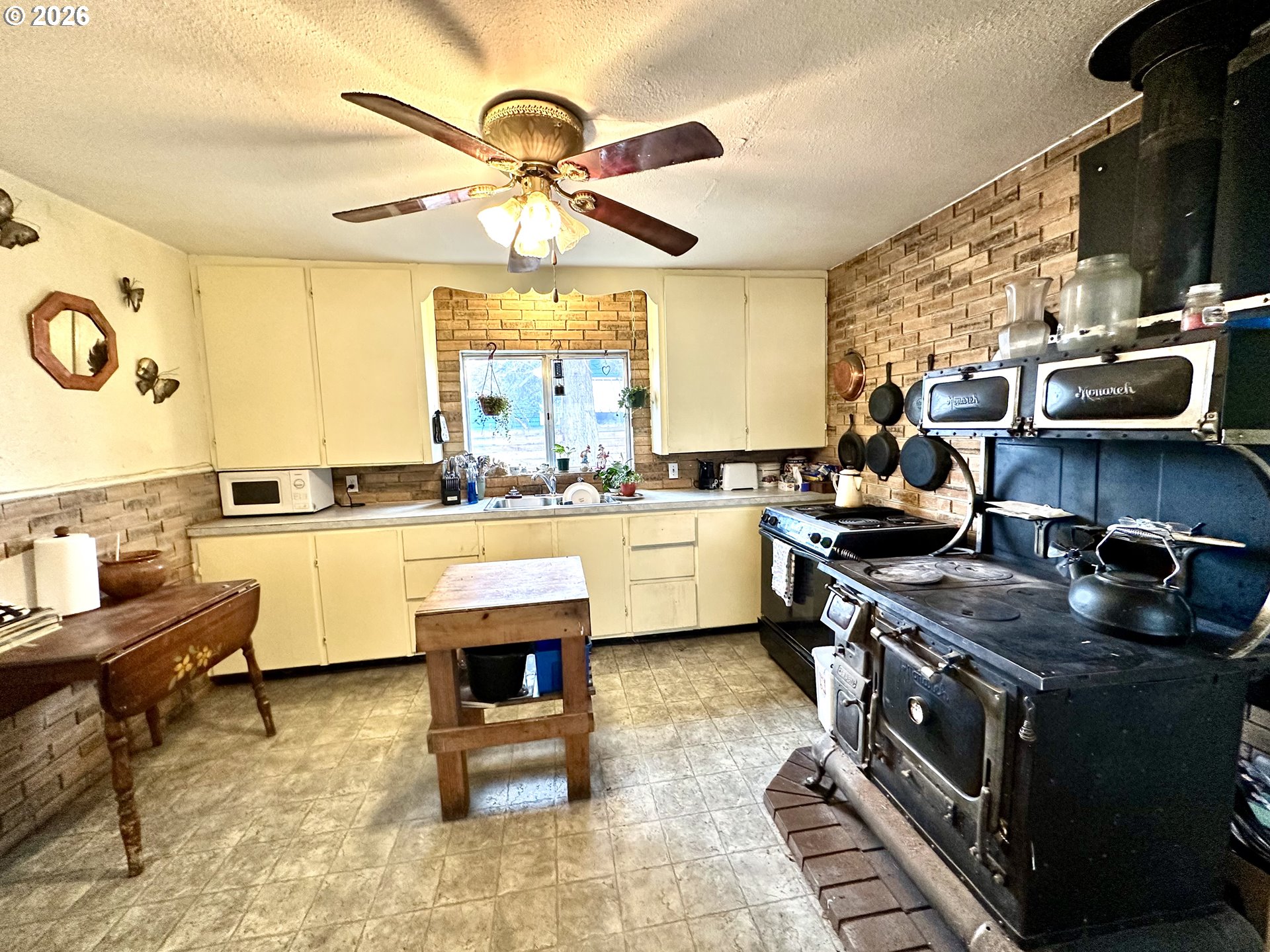 1917 Ash Street Baker City, OR 97814 - Photo 2 of 27 a kitchen with a stove a sink and a refrigerator