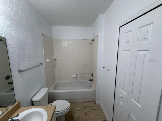 a bathroom with a tub toilet and sink