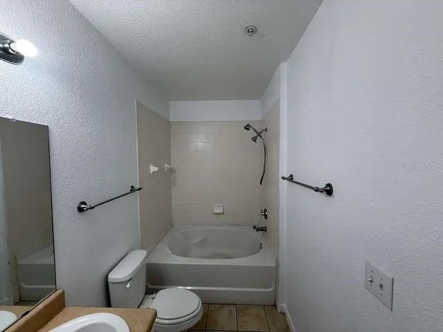 a bathroom with a toilet a sink and shower