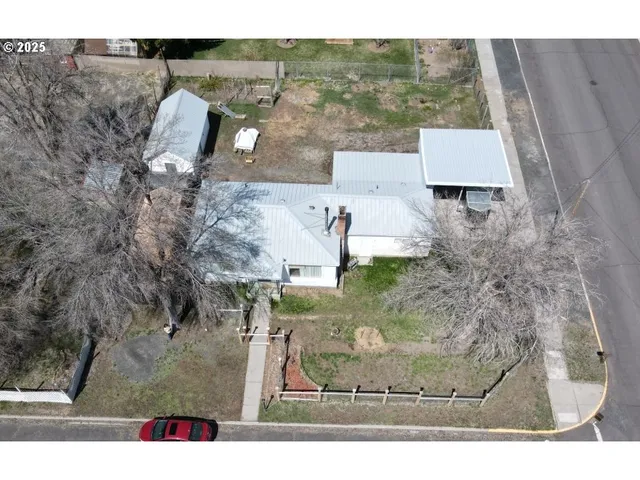 a patio with a table and chairs under an umbrella