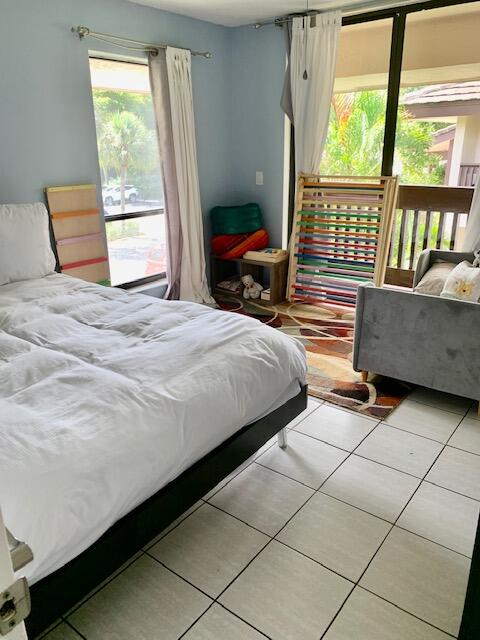 9256 Sable Ridge Circle, Unit B Boca Raton, FL 33428 - Photo 19 of 21 a bedroom with a bed and a large window