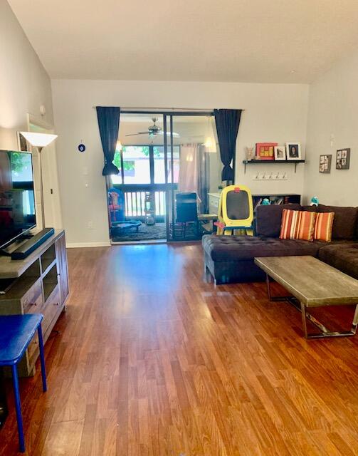 9256 Sable Ridge Circle, Unit B Boca Raton, FL 33428 - Photo 3 of 21 a living room with furniture and a flat screen tv