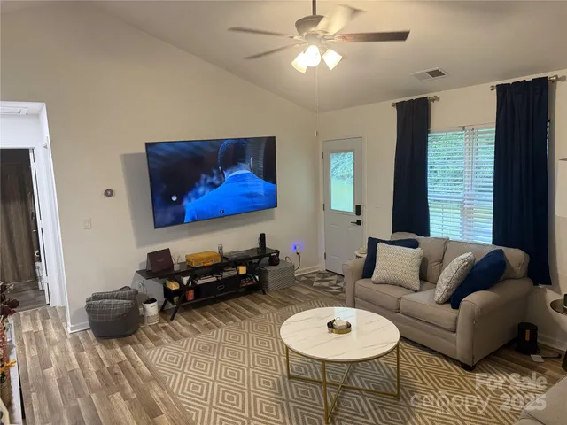 a living room with furniture a rug and a window