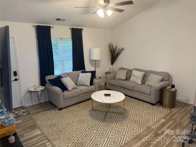 a living room with furniture and a rug