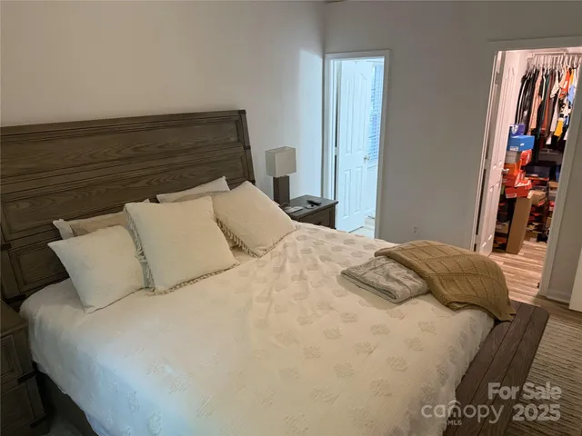 a bedroom with a bed and a book shelf