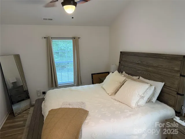 a bedroom with a bed and window