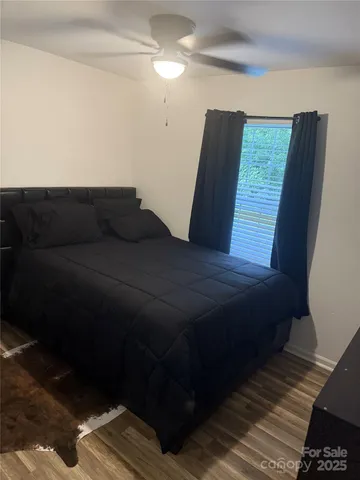 a bed sitting in a bedroom next to a window