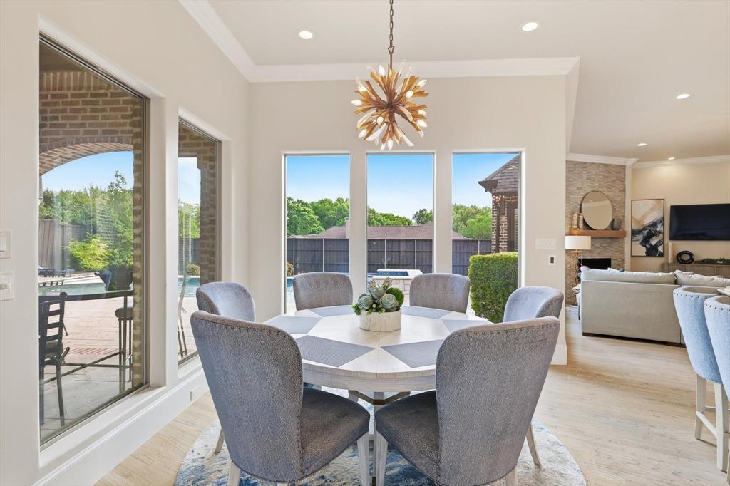 476 Hidden Valley Lane Coppell, TX 75019 - Photo 12 of 40 a dining room with furniture a rug and a chandelier