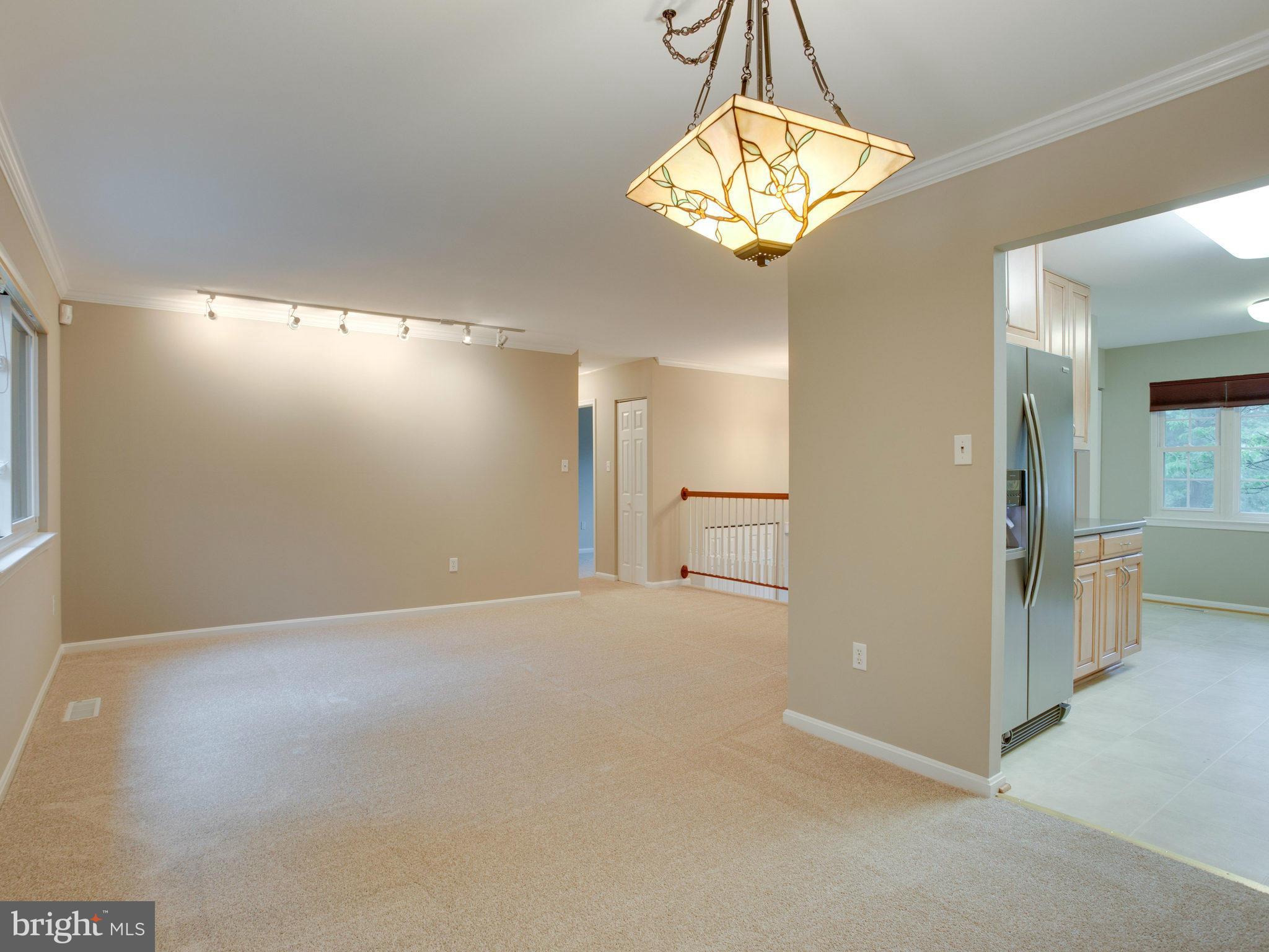 2323 Archdale Road Reston, VA 20191 - Photo 10 of 30 en empty room with windows and chandelier