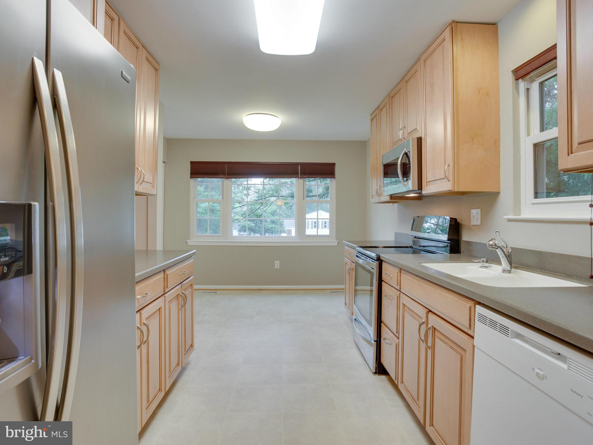 2323 Archdale Road Reston, VA 20191 - Photo 11 of 30 a kitchen with stainless steel appliances granite countertop a refrigerator a sink dishwasher a stove and white countertops with wooden floor