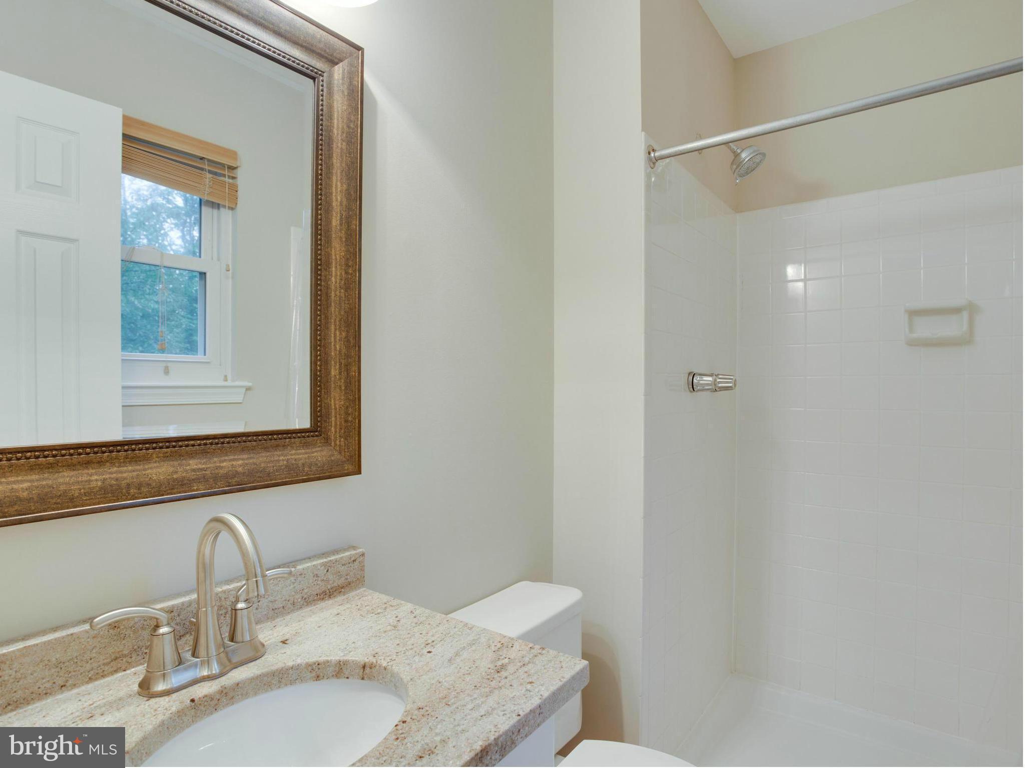 2323 Archdale Road Reston, VA 20191 - Photo 14 of 30 a bathroom with a granite countertop sink and a mirror