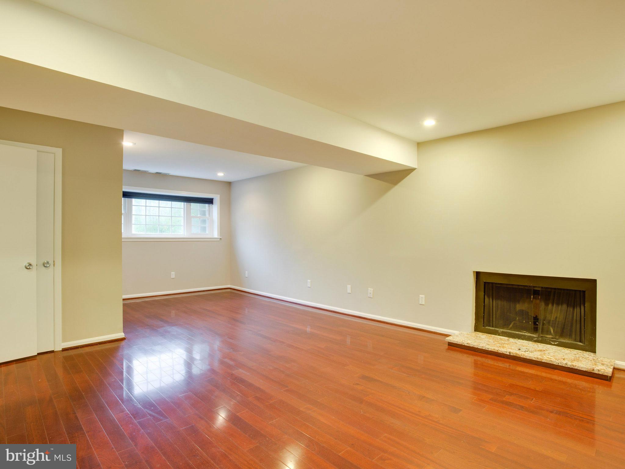 2323 Archdale Road Reston, VA 20191 - Photo 18 of 30 a view of an empty room with wooden floor and a fireplace