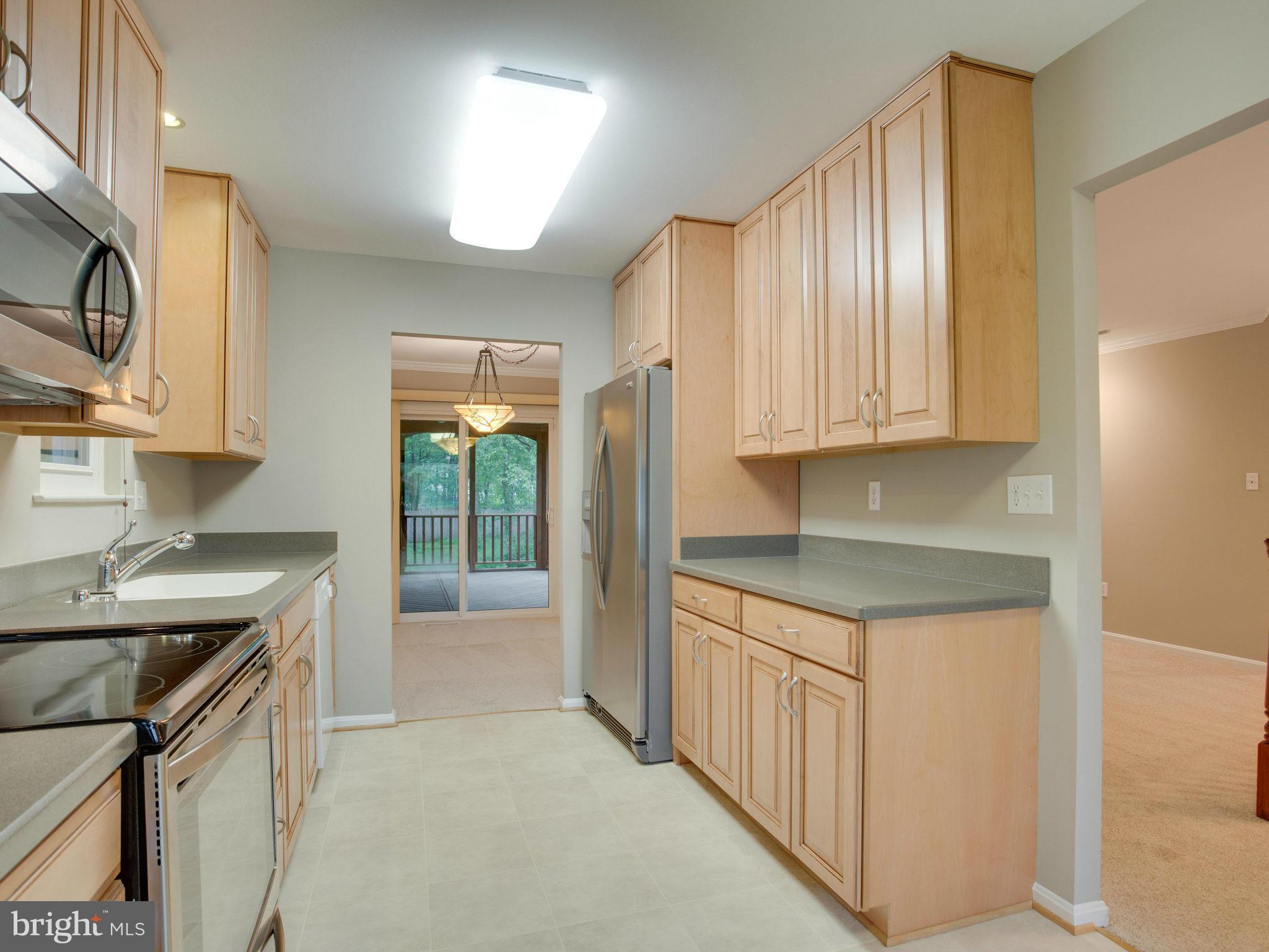 2323 Archdale Road Reston, VA 20191 - Photo 2 of 30 a kitchen with stainless steel appliances granite countertop a sink and cabinets