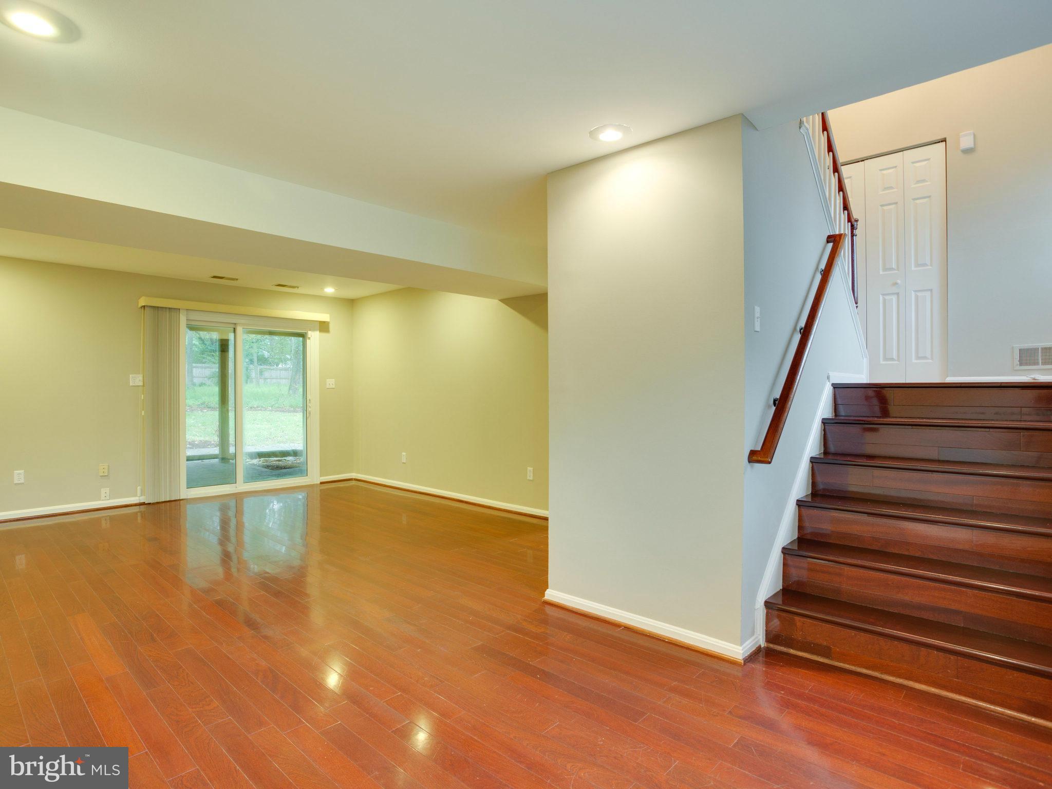 2323 Archdale Road Reston, VA 20191 - Photo 3 of 30 a view of an empty room with wooden floor and stairs